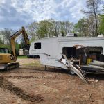 Camper being removed from yard