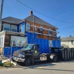 Reeds truck and dumpster parked outside of house during renovation