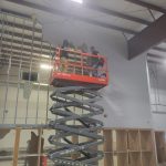 Two workers from Reeds Dumpsters and Demolition LLC in a lift