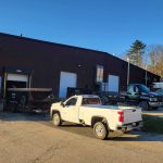 Reeds trucks and dumpsters parked outside of warehouse