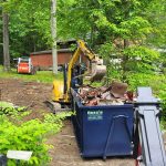 Demolition contractor loading up rental dumpster from Reeds Dumpsters and Demolition LLC