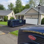 Rental dumpster from Reeds Dumpsters and Demolition LLC in driveway