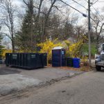 Rental dumpster from Reeds Dumpsters and Demolition LLC in driveway