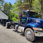 Reeds Dumpsters and Demolition LLC truck dropping off a rental dumpster