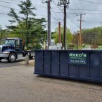 Rental dumpster from Reeds Dumpsters and Demolition LLC photographed with truck
