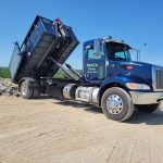 Reeds Dumpsters and Demolition LLC truck unloading a dumpster