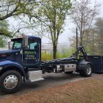 Reeds Dumpsters and Demolition LLC truck dropping off a rental dumpster