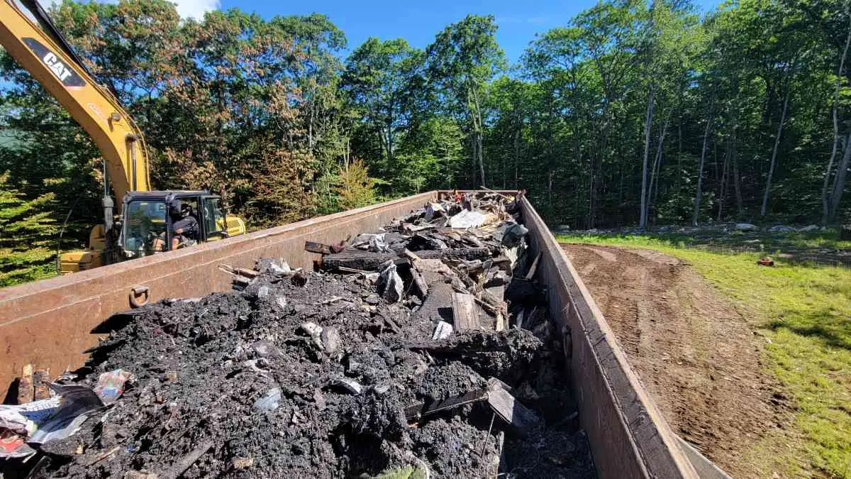 Reeds Dumpsters and Demolition LLC truck roll-off dumpster filled